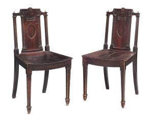 A pair of carved cedar hall chairs, 19th Century.