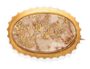 A gold quartz brooch, circa 1870,  the oval polished quartz panel  set in fluted surround. Yellow gold. Weight 15.39 grams. Length 4cm. 