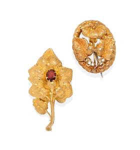 Two gold foliate brooches, one of oval form, the other a garnet set leaf brooch. Yellow gold. Weight 6.83 grams. 