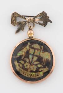 An opal chip pendant, circa 1900, one side of the circular pendant with the Australian coat of arms, the other with the name "Allie". 9ct rose gold. 9ct silver lined bow surmount. Diameter 3.3cm. A similar example illustrated Australian Jewellery, 19th & 