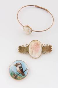 A small collection of jewellery including a conch shell cameo bar brooch and bangle and a porcelain Kookaburra brooch. 9ct yellow and rose gold.