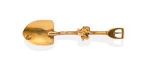 A gold miner's brooch, the handle of the shovel with applied gold nuggets. Yellow gold. Weight 4.99 grams. Repaired.