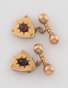 A pair of garnet cufflinks, Johnson & Simonsen, Melbourne, shield shaped design and set with cabochon garnets. 15ct yellow gold. Weight 6.31 grams. Non-original box.