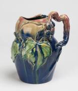 Remued Pottery ​A blue glazed earthenware jug with applied grapes leaves