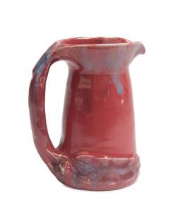 Philippa James (1893-1967) A glazed earthenware gumnut and gum leaf decorated pink glazed jug