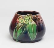 Remued Pottery A blue and red glazed earthenware vase with applied gumnuts and gum leaves