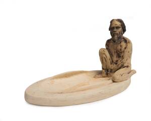 William Ricketts (1898-1993) An earthenware coolamon dish decorated seated Aboriginal figure