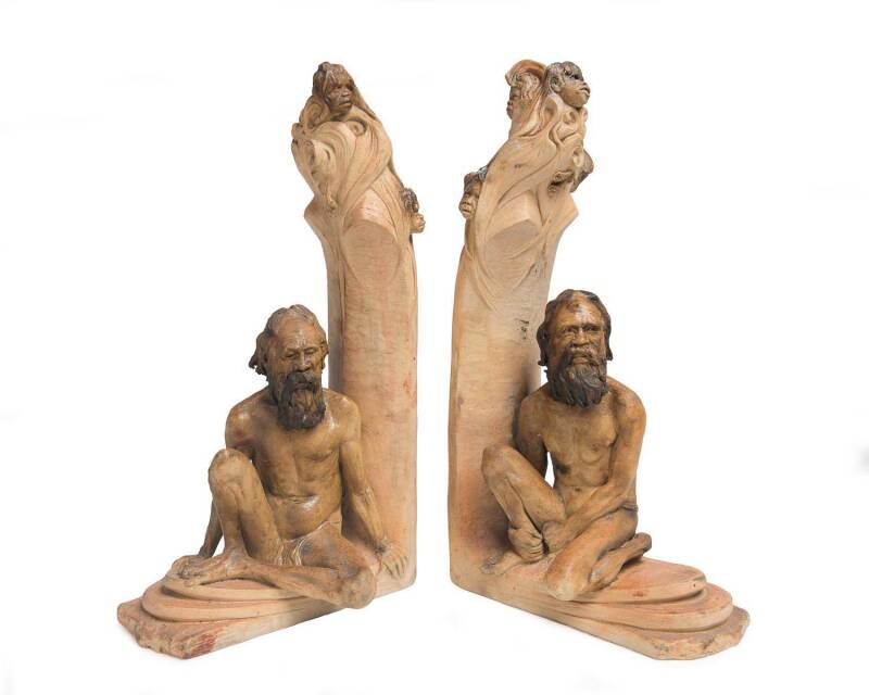 William Ricketts (1898-1993) A pair of glazed earthenware bookends with moulded seated Aborignal elders