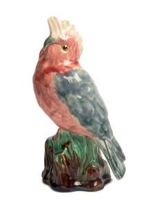 Grace Seccombe (1880-1956) A slip cast hand finished glazed eathenware figure of a pink and gray galah