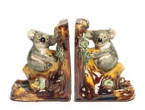 Grace Seccombe (1880-1956) A pair of glazed earthenware koala decorated bookends