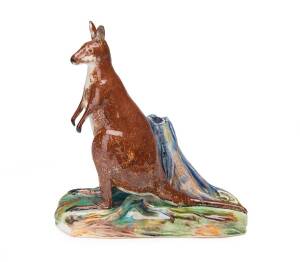 Grace Seccombe (1880-1956) A slip cast, hand-finished, earthenware figure of a kangaroo standing alongside a tree stump 1942