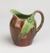 Remued Pottery A brown and green glazed earthenware jug with applied gumnuts and gum leaves