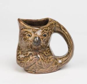 Arthur Gilbert (attrib.) A green glazed earthenware koala jug