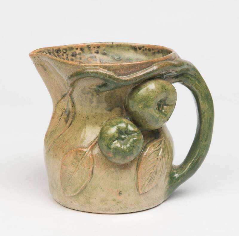 William Merric (Merric) Boyd (1888-1959) A green glazed earthenware jug decorated in high relief with apples and leaves