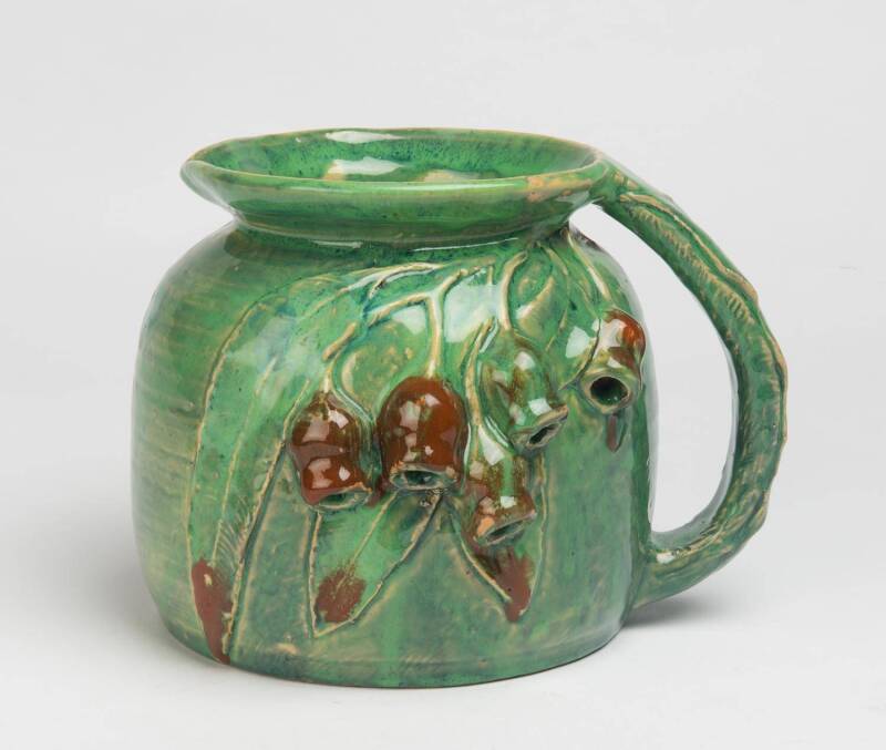 Alison Davidson (active 1933) A large green glazed earthenware jug with applied gum nuts