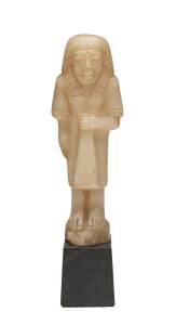 Egyptian carved alabaster figure, New Kingdom with remains of paper label on the base (illegible), 1400-1200 B.C. Statue not including base, 19cm
