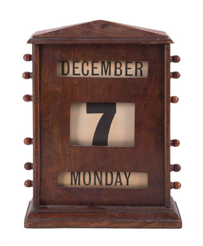 A timber desk calendar, English oak, circa 1900. 34cm