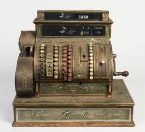 An "International" antique American brass cash register. 55cm high, 59cm wide, 38cm deep. 