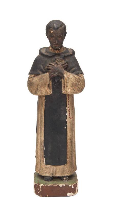 A rare Indo-Portuguese painted clay statuette of St.Martin de Porres, holding a crucifix and rosary, Goa, India, late 18th early 19th Century. 24cm.Provenance: From the Estate of Mr Mahinda Dharmapala of Colombo, Sri Lanka, former antique collector/dealer