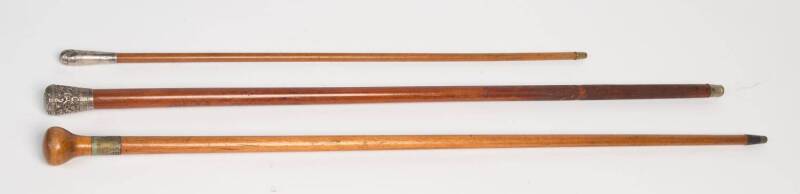 Two antique walking sticks and a swagger stick with silver and silver plated tops. Late 19th early 20th Century Longest. 93cm