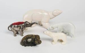 A Royal Copenhagen porcelain polar bear (18cm long), two other porcelain polar bears (14cm & 30cm), a stone hippopotamus (13cm long), and a silver plate elephant pin cushion (19cm long)