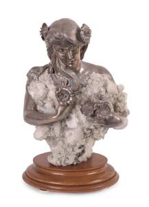 An impressive Art Nouveau style bust. Hand beaten silver applied to natural quartz crystal specimen, stamped 925 PLATA with artist signature (illegible) on wooden base. 20th Century. 44cm