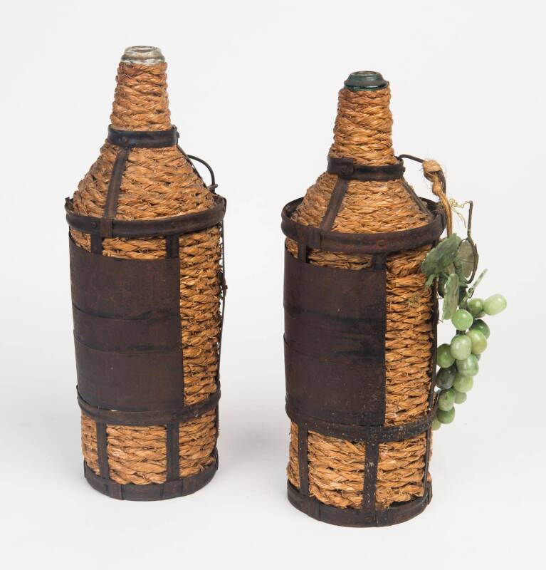 A pair of Italian raffia and metal bound wine bottles together with a small bunch of hard stone grapes