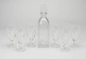 An Orrefors decanter and six waterford champagne flutes. Decanter 28cm.