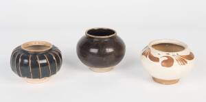 Three Chinese stoneware jars including one Cizhou type jar, one black glazed jar and one black glaze ribbed jar, Jin dynasty and later. 8-10cm high Provenance: The Dr. Steven Zador Collection.