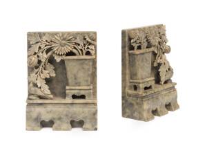 A pair of Chinese soapstone bookends, carved with vases and blossom, circa 1900. 17cm high
