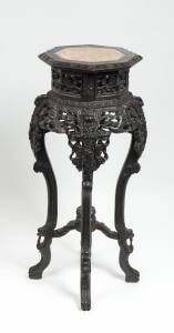 A Chinese carved hardwood hexagonal stand with marble top, late 19th to early 20th Century. 90cm high.