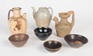 A group of four black glazed bowls (11cm to 15cm); &nbsp;together with three ewers (18cm to 20cm)&nbsp;
