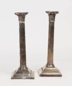 A George V pair of sterling silver Corinthian column candlesticks