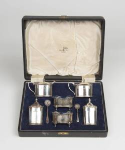 A boxed sterling silver six piece condiment set by Walker & Hall of Sheffield, 1931. (Also includes 2 spoons)