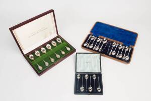 A box set of sterling silver spoons with the Australian state flowers, together with a box set of 6 Walker & Hall sterling silver coffee spoons. Plus silver plated spoons and tongs in box.&nbsp;