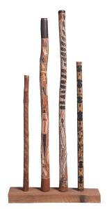 A group of 4 didgeridoos including 2 fine hand painted examples from Yirkala with yam and animal totems, carved frog dreaming from Rose River & a children's example from Delessaville. All collected by the vendor in 1972 & 1973. Longest: 155cm. Provenance: