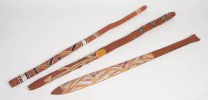 Group of three painted Aboriginal ceremonial clubs and sticks, Arnhem Land origin. Longest 115cm. Provenance: Exhibited Expo 1988 Brisbane 