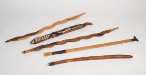 A group of 5 Aboriginal artifacts including a woomera, adze, carved totem and two snakes. Longest: 87cm. 