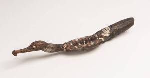 A flute stopper, Papua New Guinea, carved wood and natural earth pigments with shell inlaid eyes, mid 20th Century. 41cm