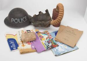 WW2 period collection including a gas mask, police helmet with original black painted finish, field dressing, two "Air Raid Precautions" manuals [1941], a group of handkerchiefs, tea towels etc. (20+ items)
