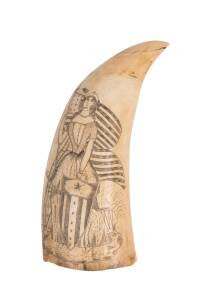 A scrimshaw whale's tooth decorated with American flags and female figure. 14cm. &diams;