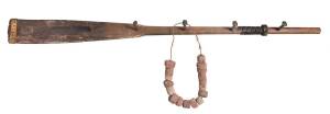 A paddle/coat rack with assorted cork floats. 191cm
