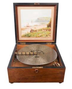 A KALLIOPE 13'' table model&nbsp;disc music box with 10 hidden bells in walnut case. Together with 46 discs in separate timber case