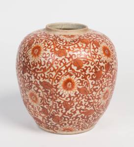 A pottery jar of ovoid form decorated in terracotta stylised floral motifs. 23cm high