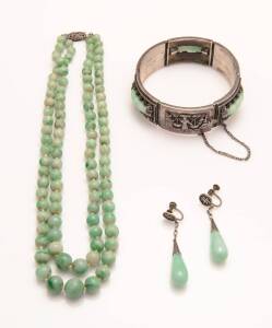 A collection of vintage Chinese jadeite jewellery comprising a graduated, double strand beaded necklace, a pair of drop earrings with screw attachments and a bracelet with figurative panels, engraved &lsquo;K.P. 18-4-37&rsquo;.