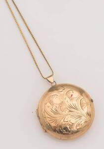 A circular gold locket, Scandia. Engraved on back "To Therese, 22nd January 1974, from Marcel". 9ct yellow gold. Weight 17.05 grams. Length of chain 30cm. Diameter of locket 37mm.