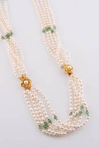 A freshwater pearl necklace and bracelet, the five strand necklace and bracelet spaced with greenstone and gold balls. Necklace length 45cm. Bracelet length 19cm.&nbsp;