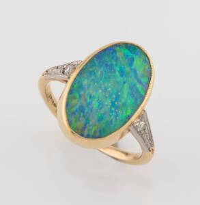 An opal doublet and diamond ring. 18ct yellow gold. Weight 2.51 grams. Size G.