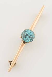 A yellow gold and blue zircon brooch. Weight 4.7 grams.