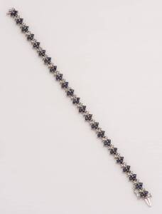 A sapphire and diamond bracelet. 10ct white gold. Weight 10.75 grams. Length 17cm.